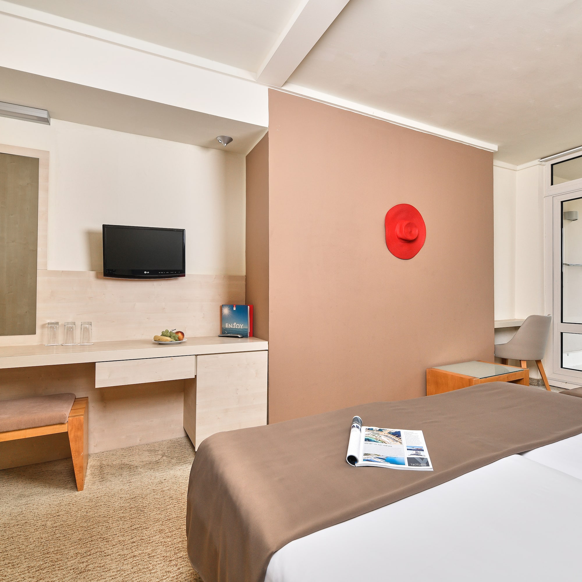 a room with a bed and a television