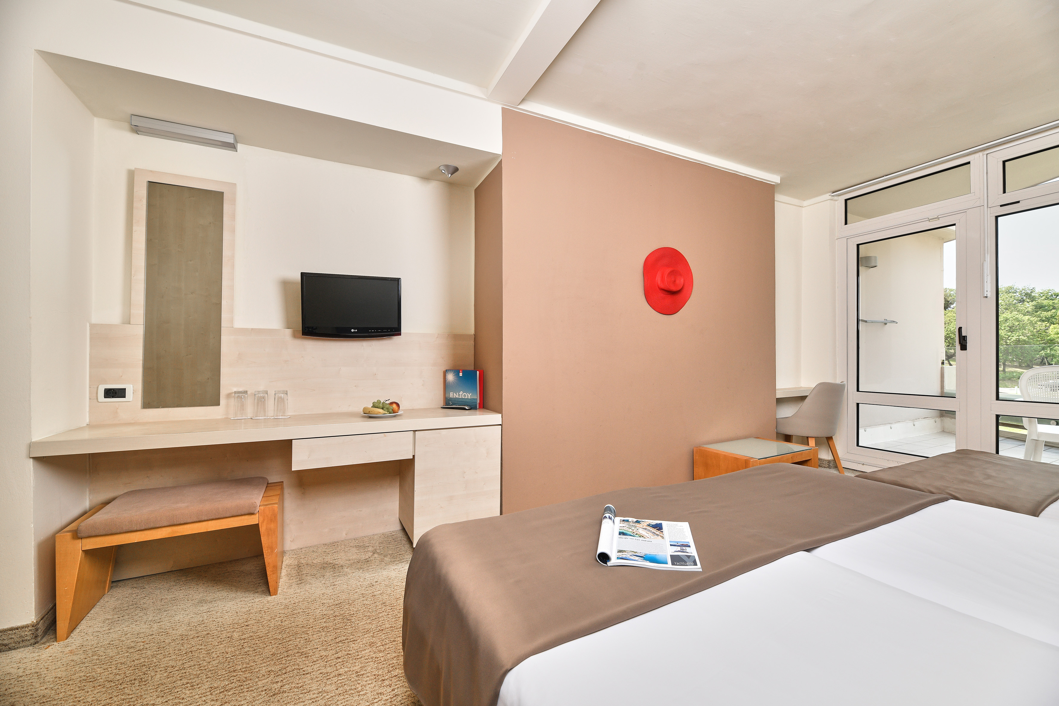 a room with a bed and a television