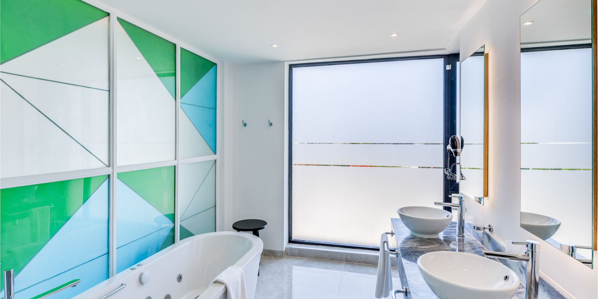 a bathroom with a tub and sinks