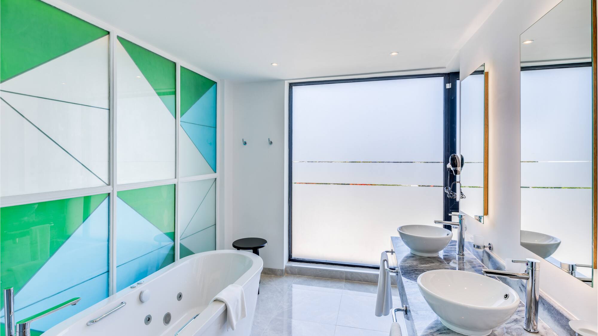 a bathroom with a tub and sinks