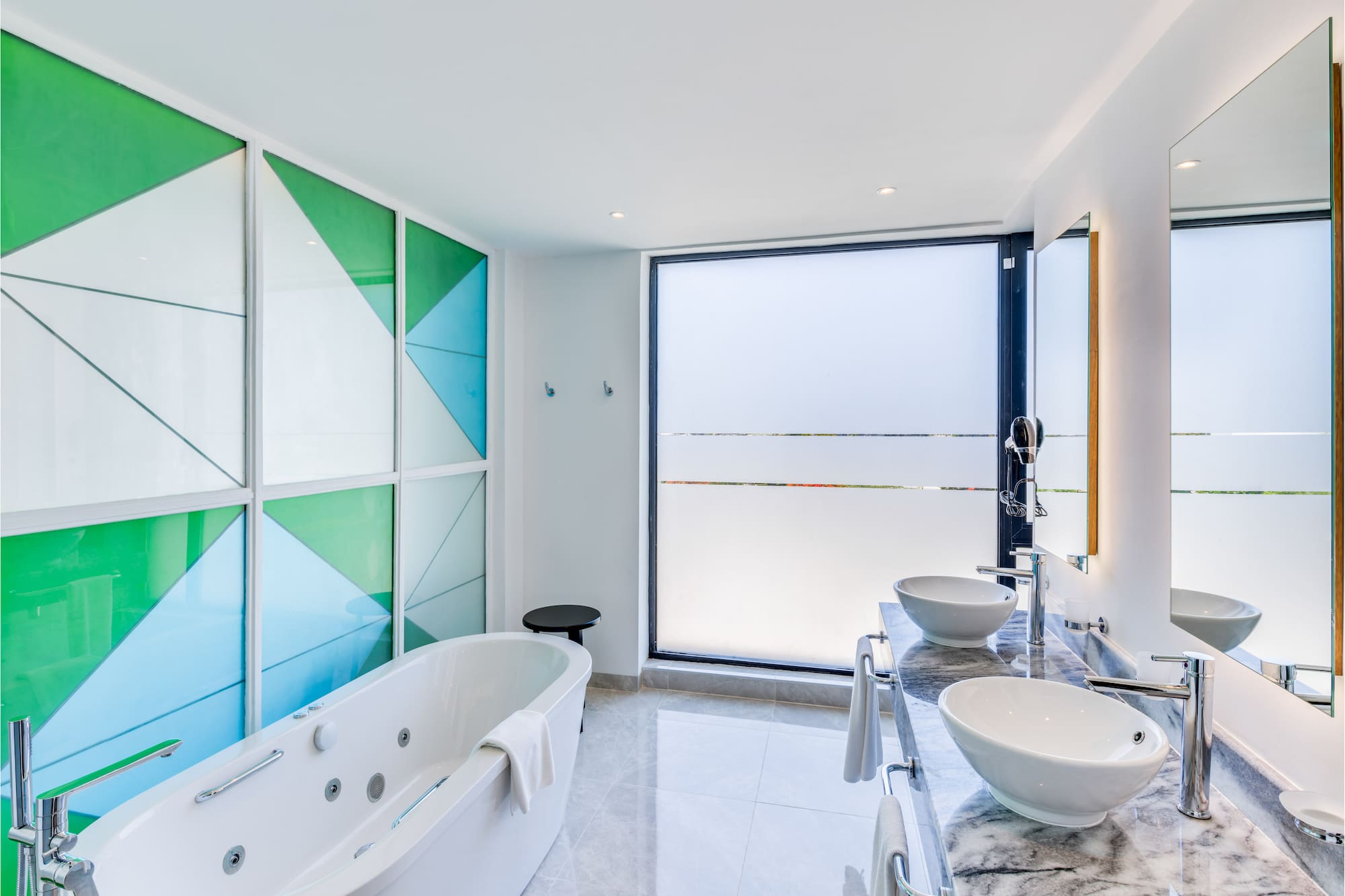 a bathroom with a tub and sinks