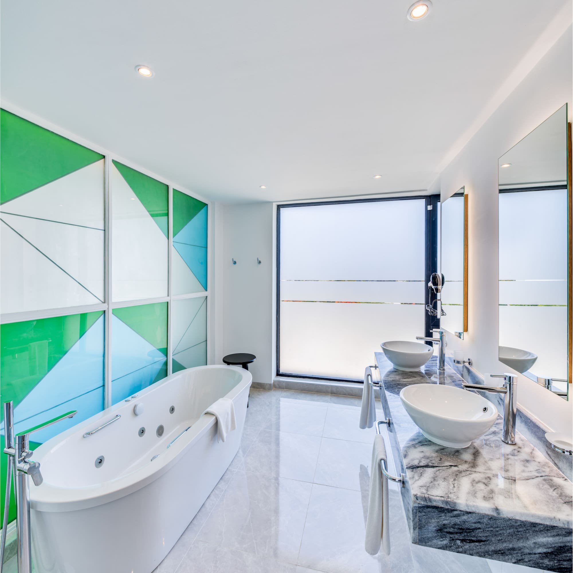 a bathroom with a tub and sinks