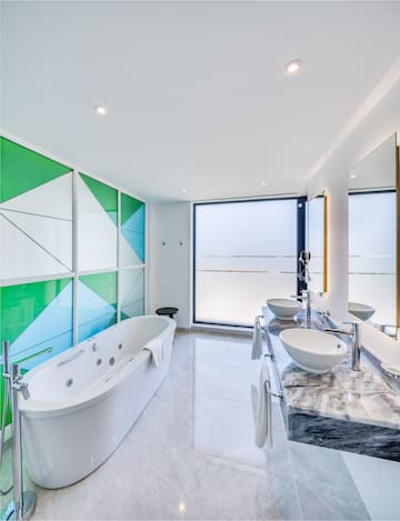 a bathroom with a tub and sinks