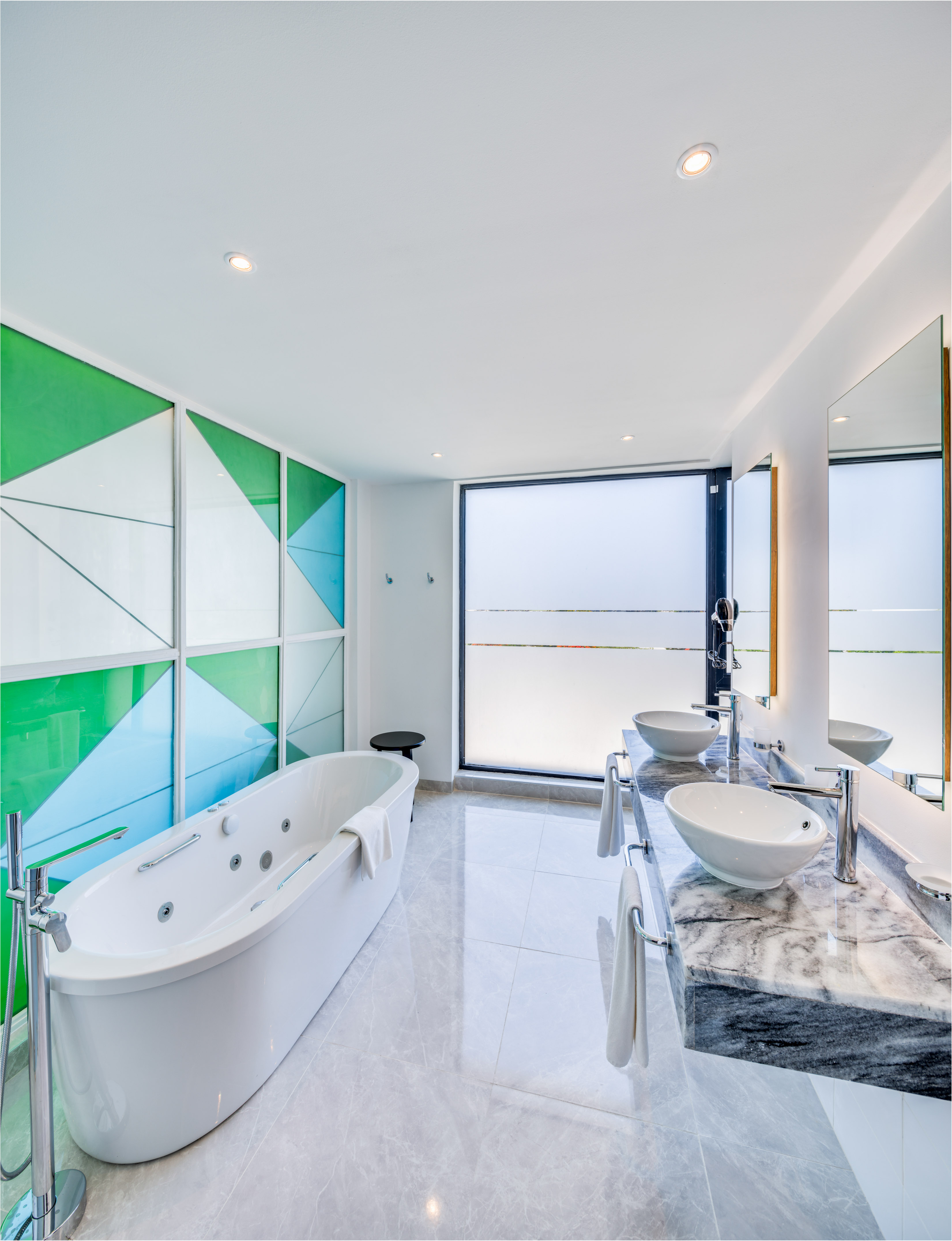 a bathroom with a tub and sinks