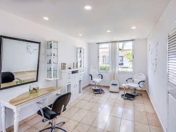 a room with chairs and a mirror