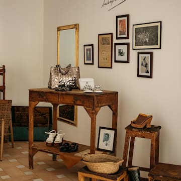 a room with a table and chairs and a mirror