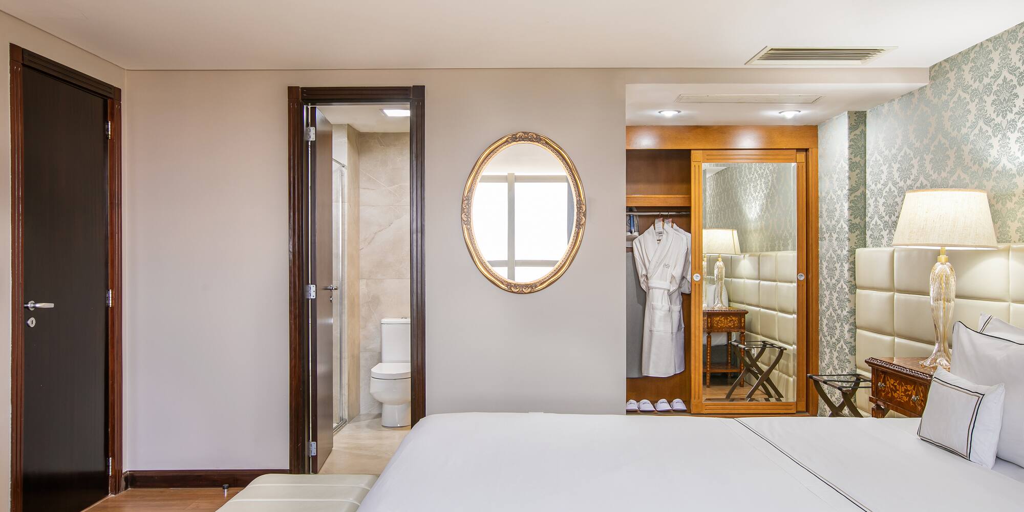 a bedroom with a mirror and a bed