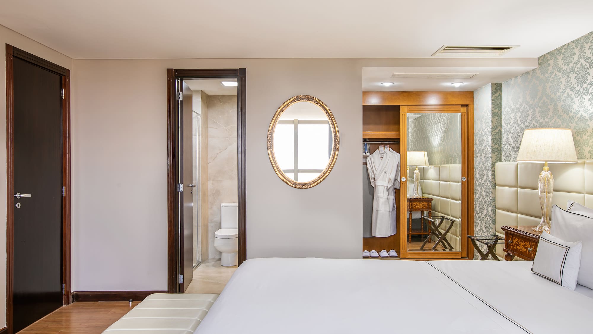 a bedroom with a mirror and a bed