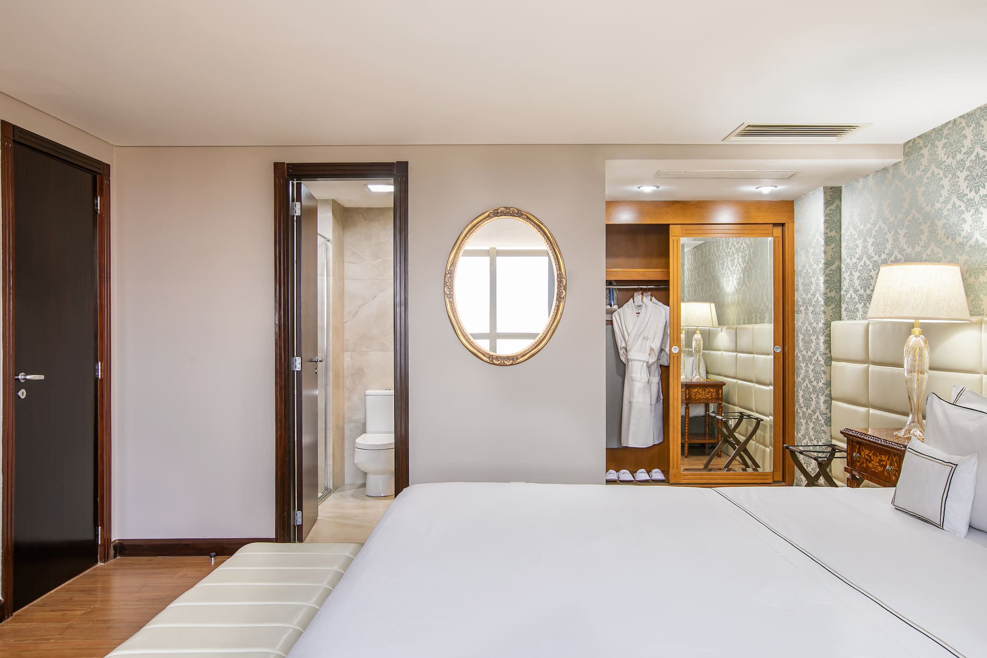 a bedroom with a mirror and a bed