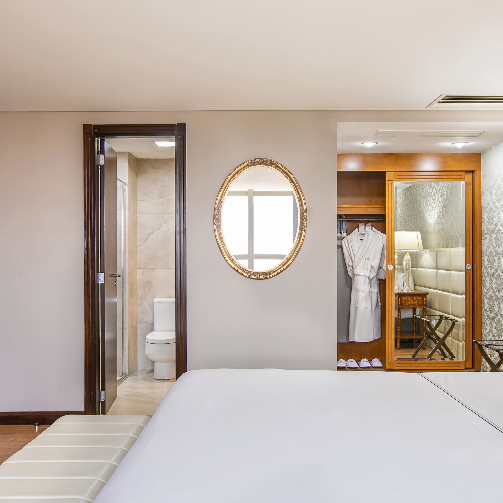 a bedroom with a mirror and a bed