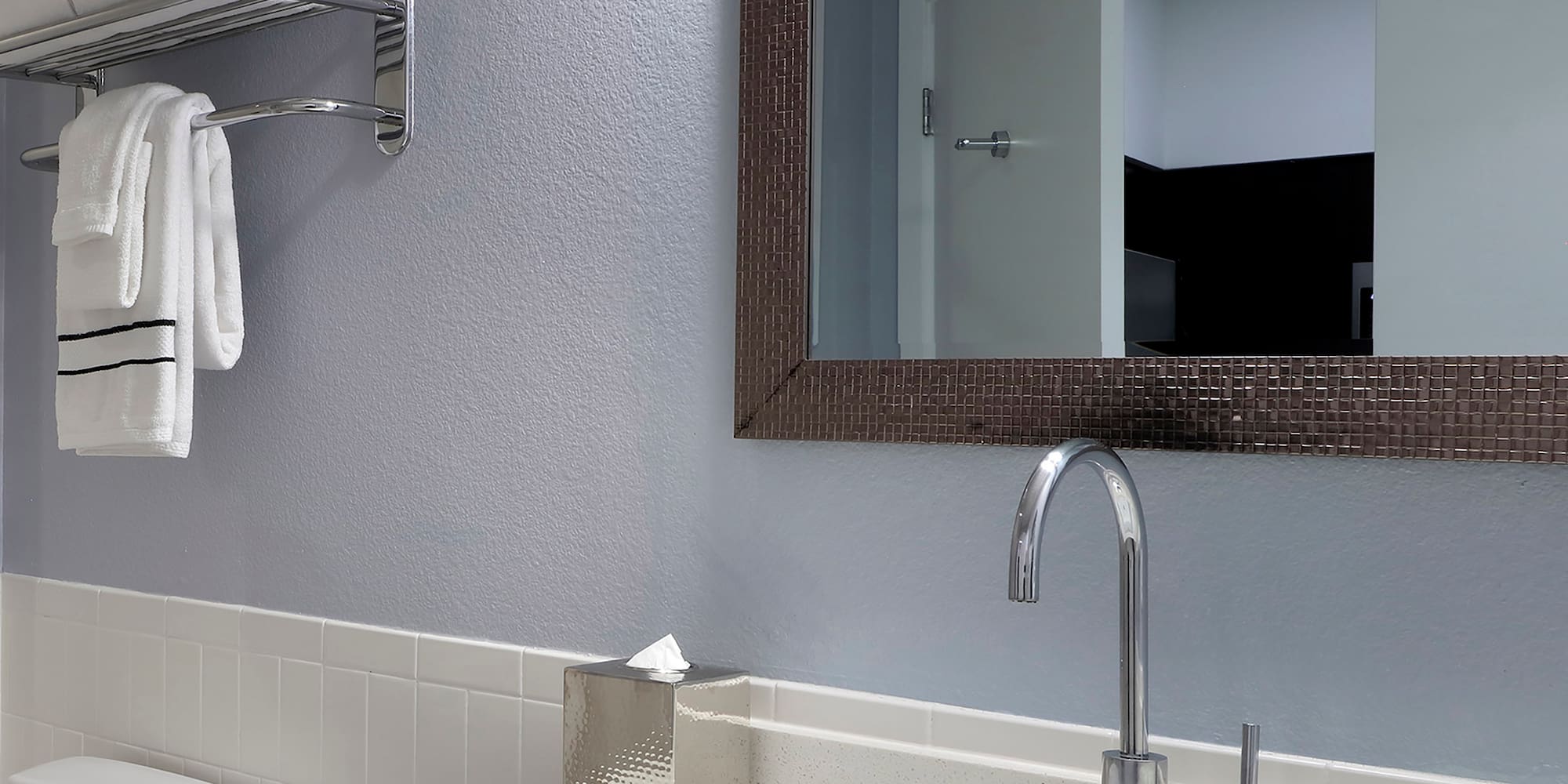 a bathroom with a mirror and sink