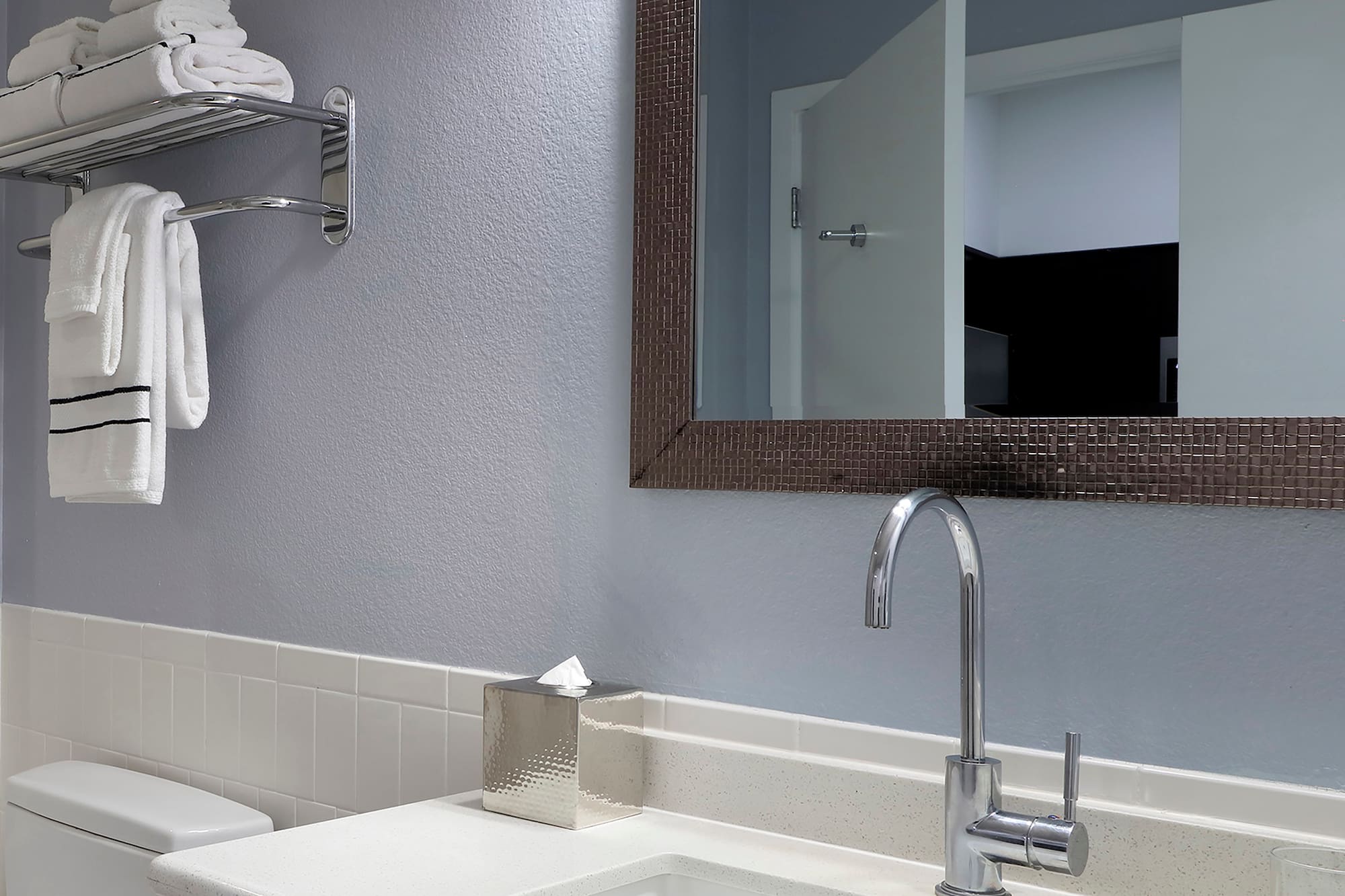 a bathroom with a mirror and sink