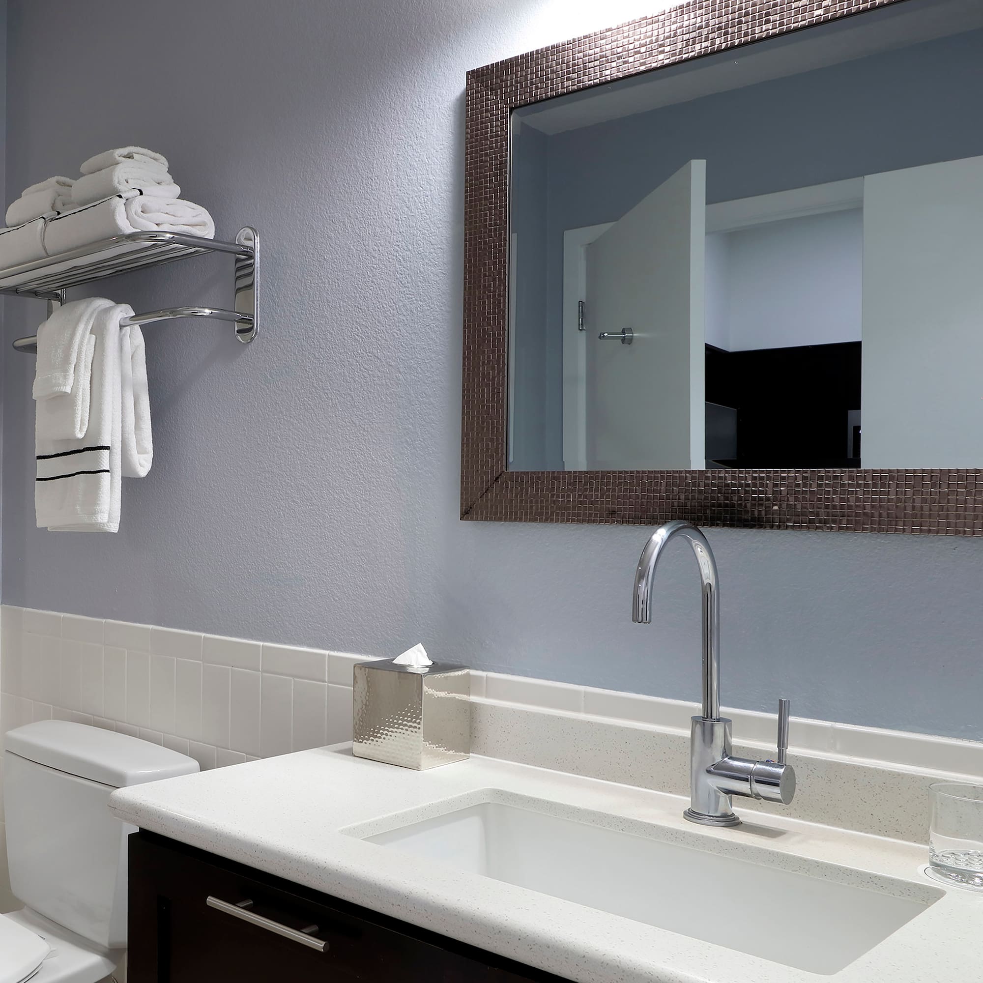 a bathroom with a mirror and sink