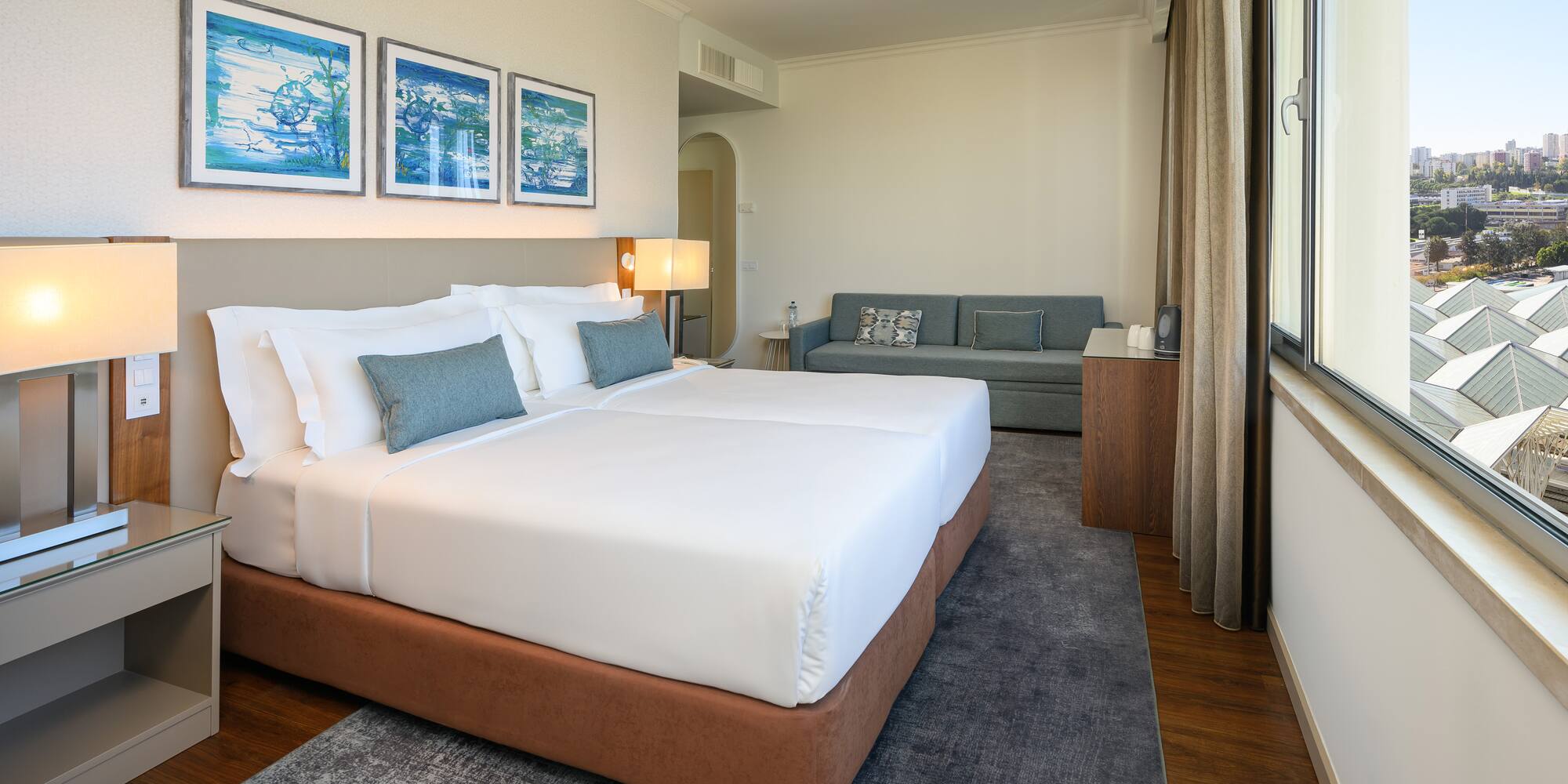 a room with two beds and a couch