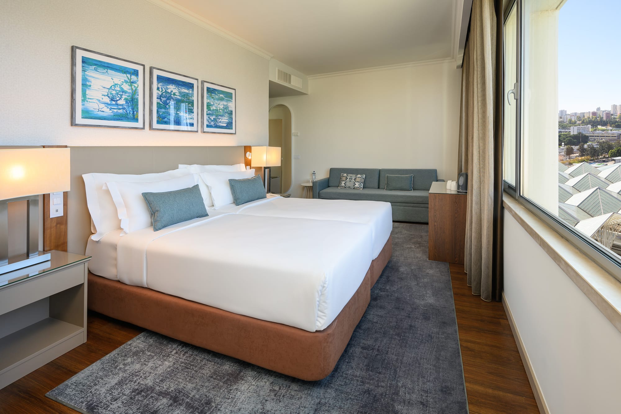 a room with two beds and a couch