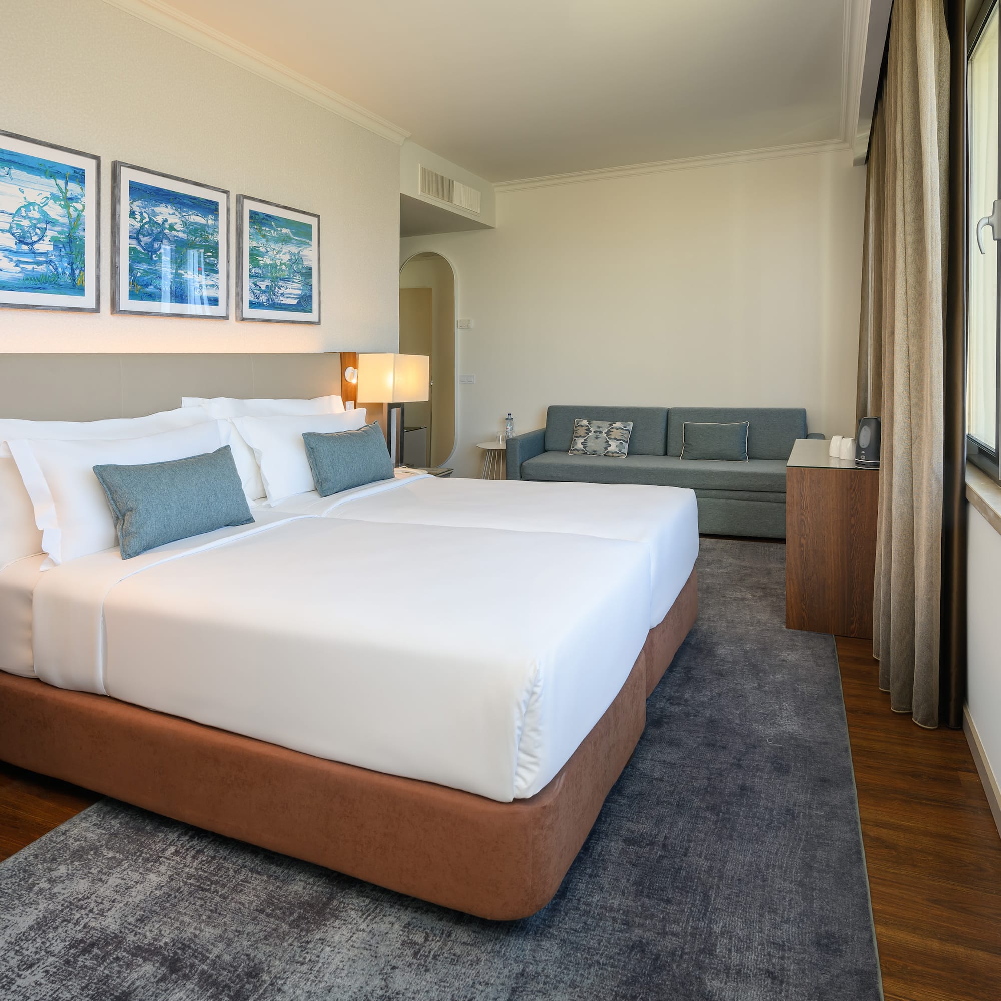 a room with two beds and a couch