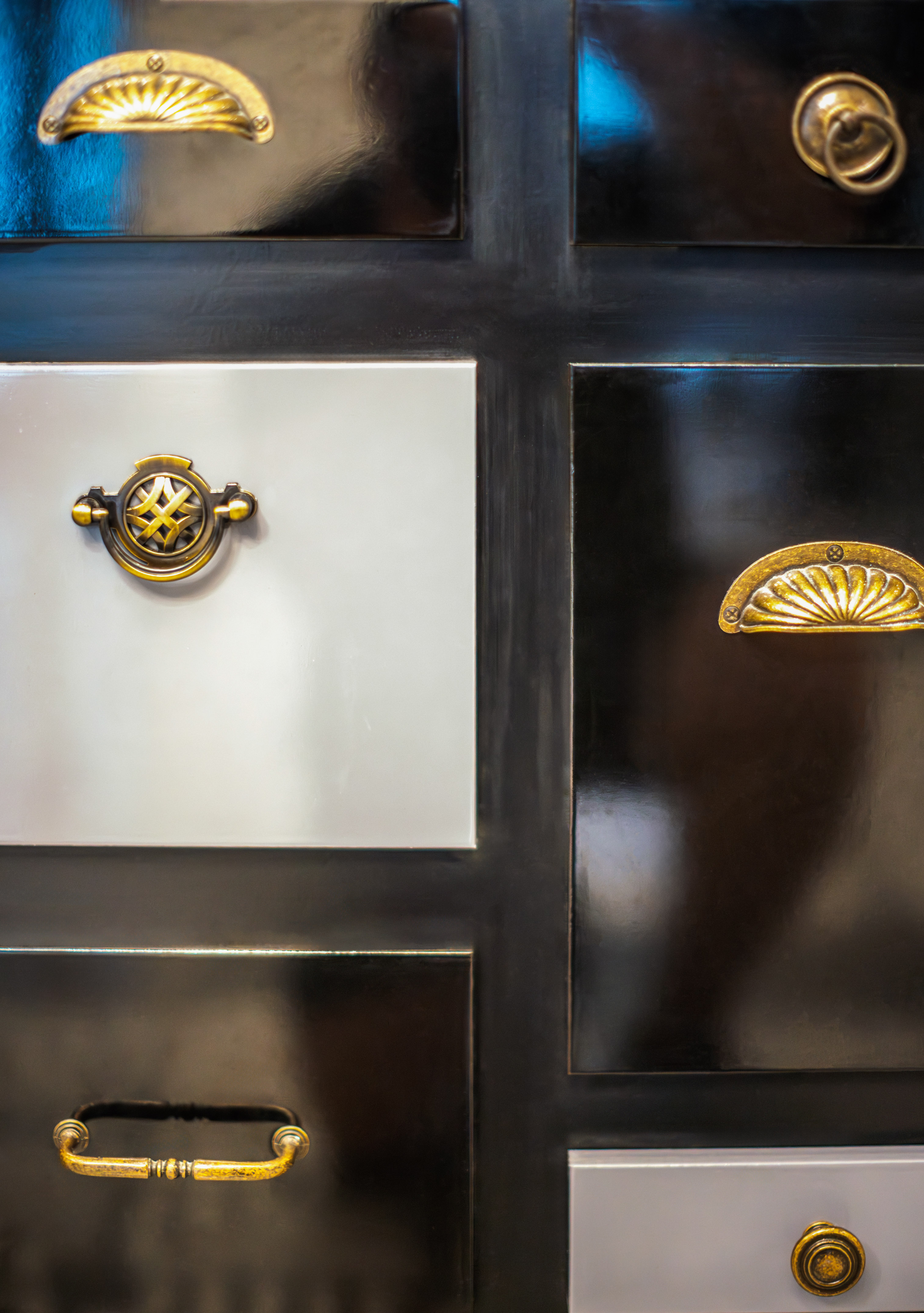 a black and white cabinet with gold handles