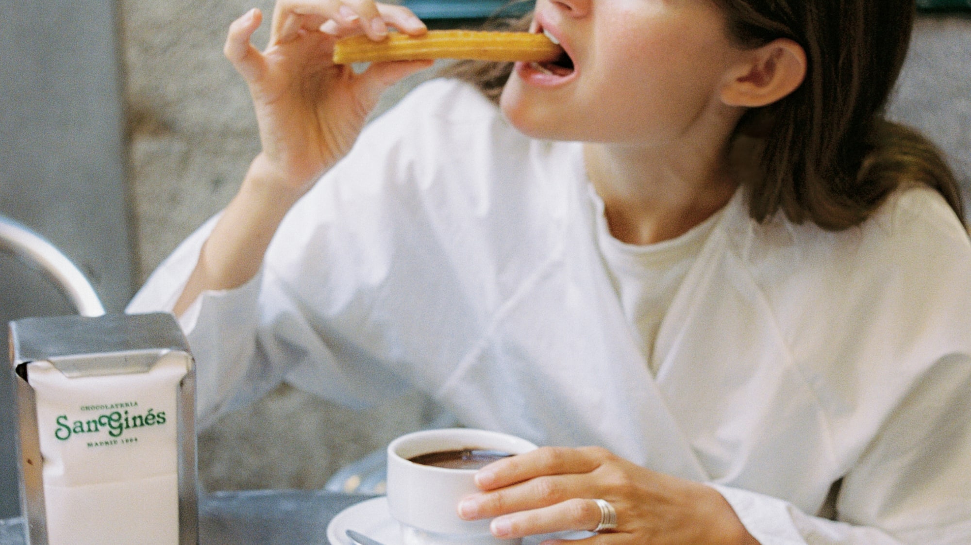 a woman eating a piece of food