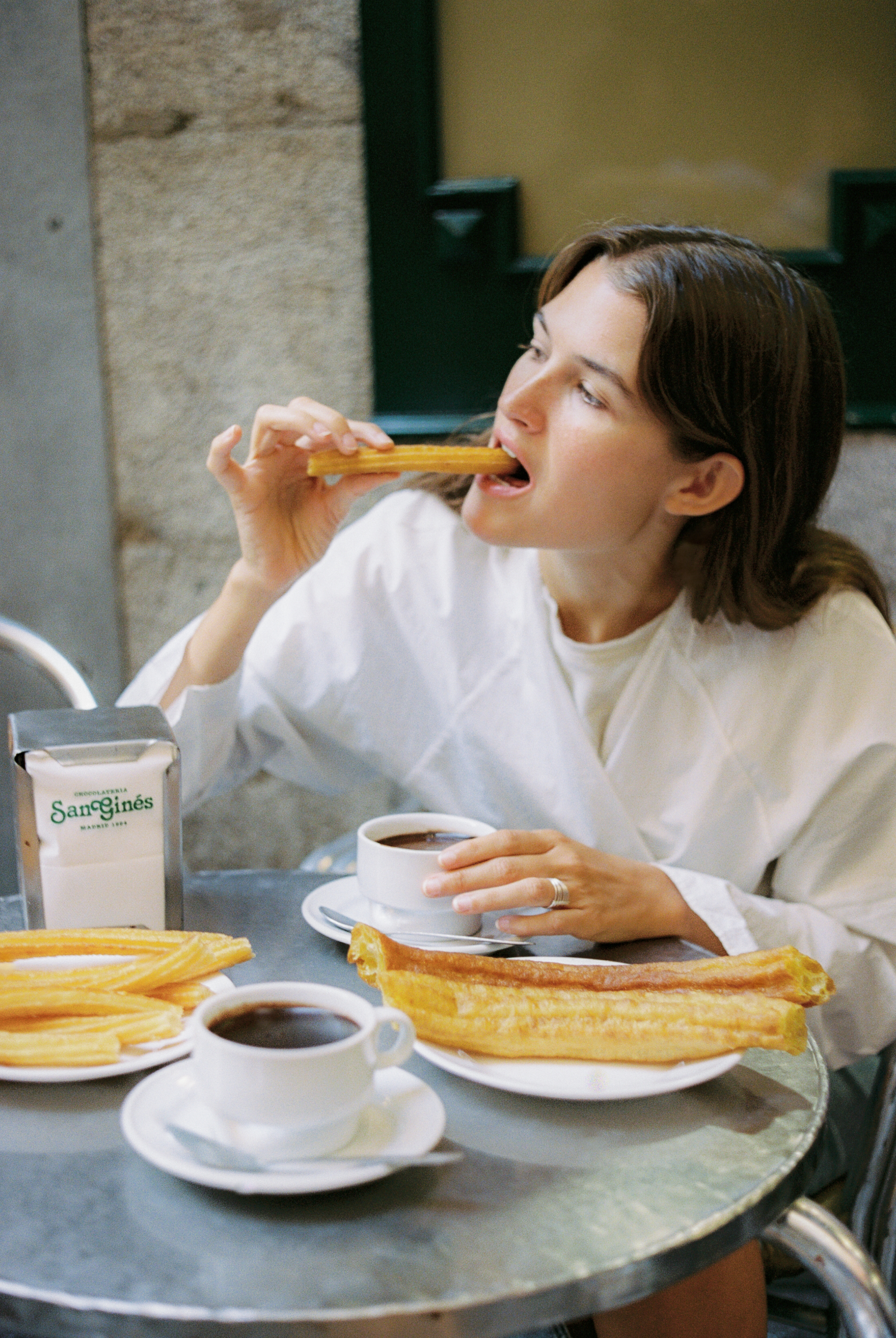 a woman eating a piece of food