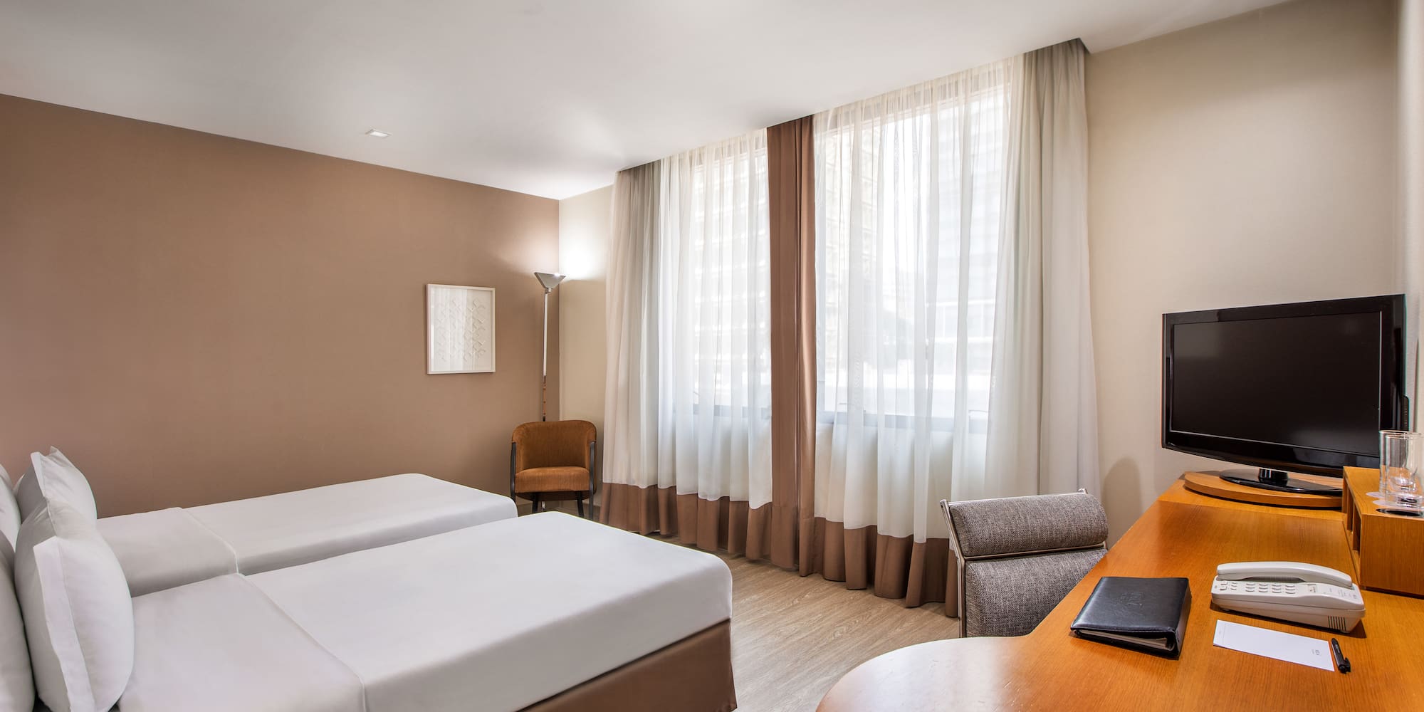 a room with two beds and a desk