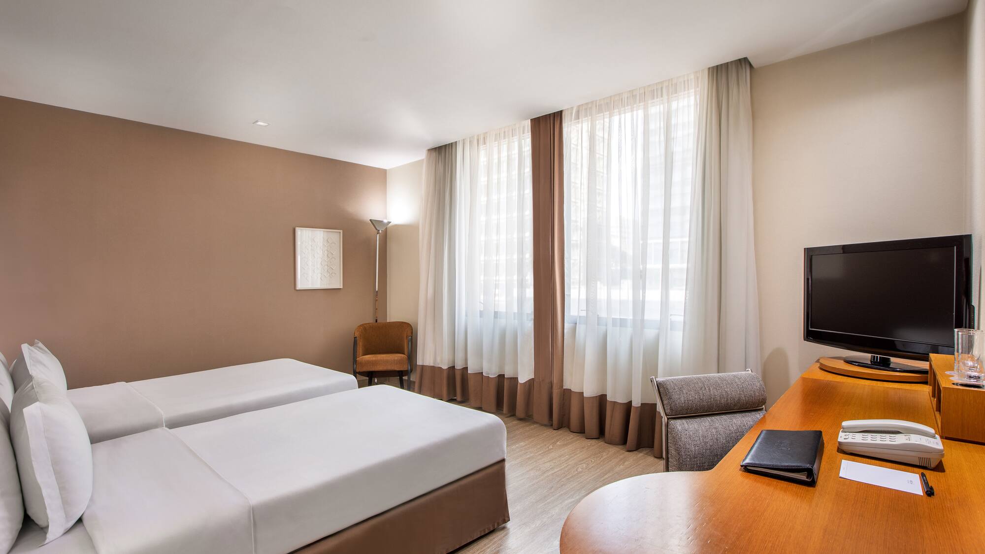 a room with two beds and a desk