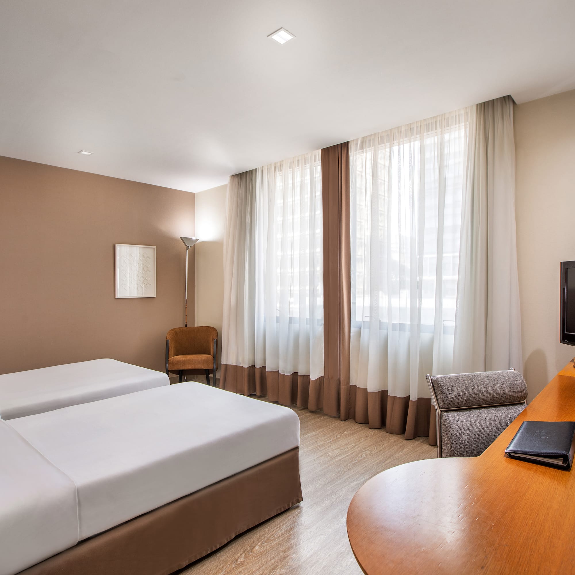 a room with two beds and a desk