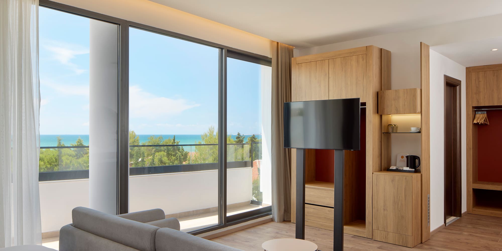 a room with a television and a large window