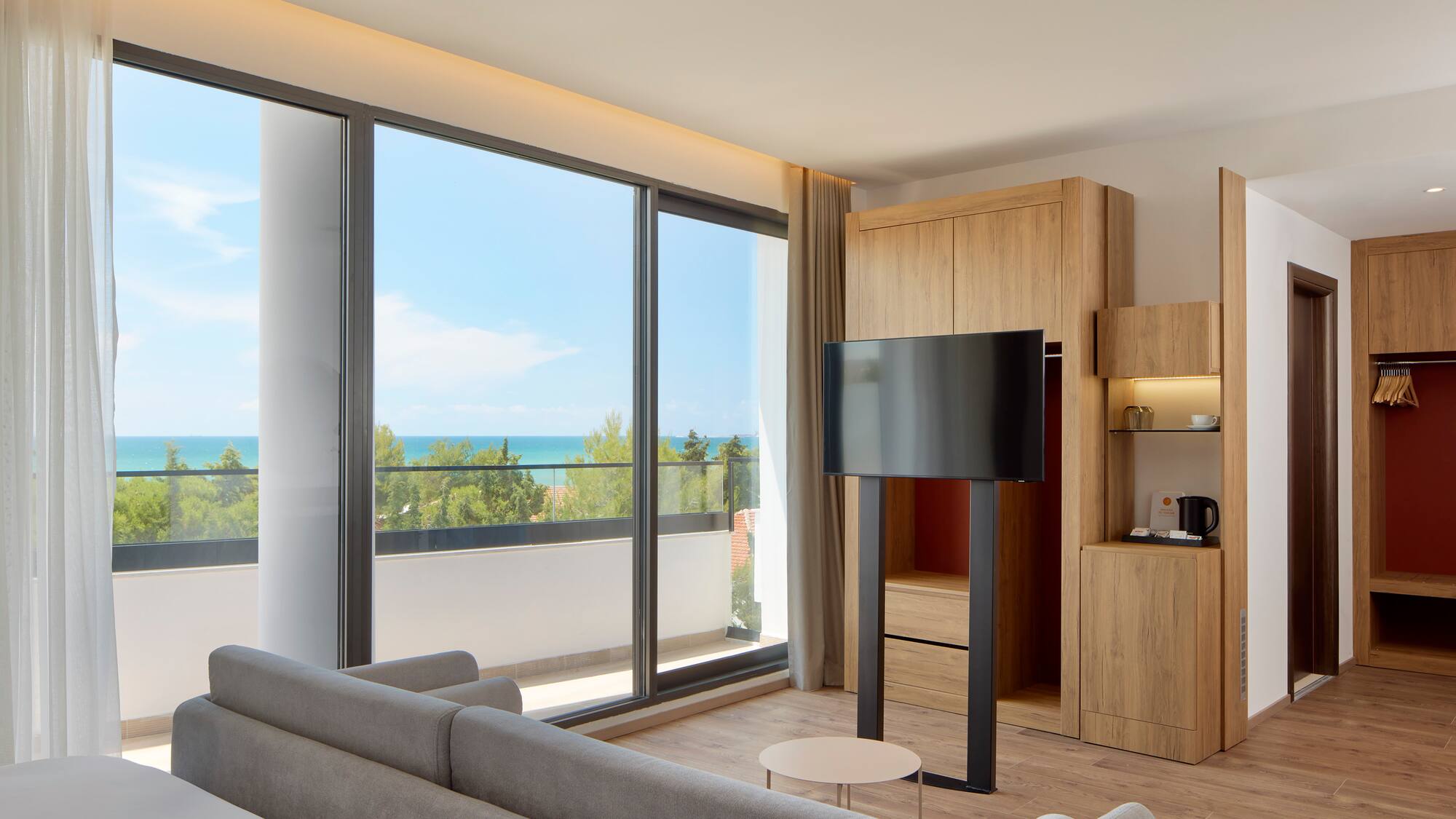 a room with a television and a large window