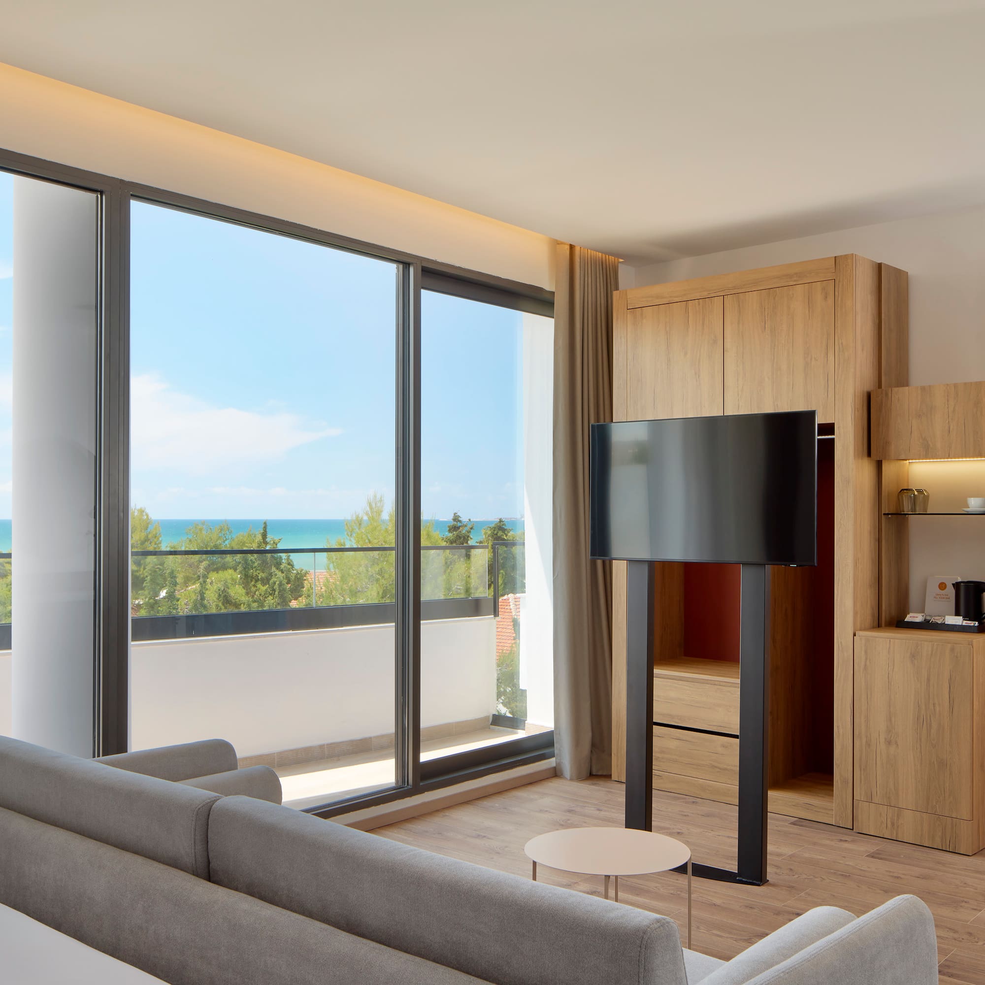 a room with a television and a large window