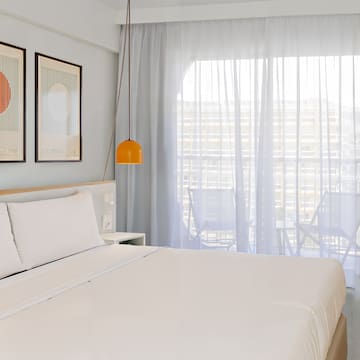 a bed with a lamp and pictures on the wall