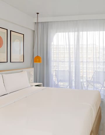 a bed with a lamp and pictures on the wall