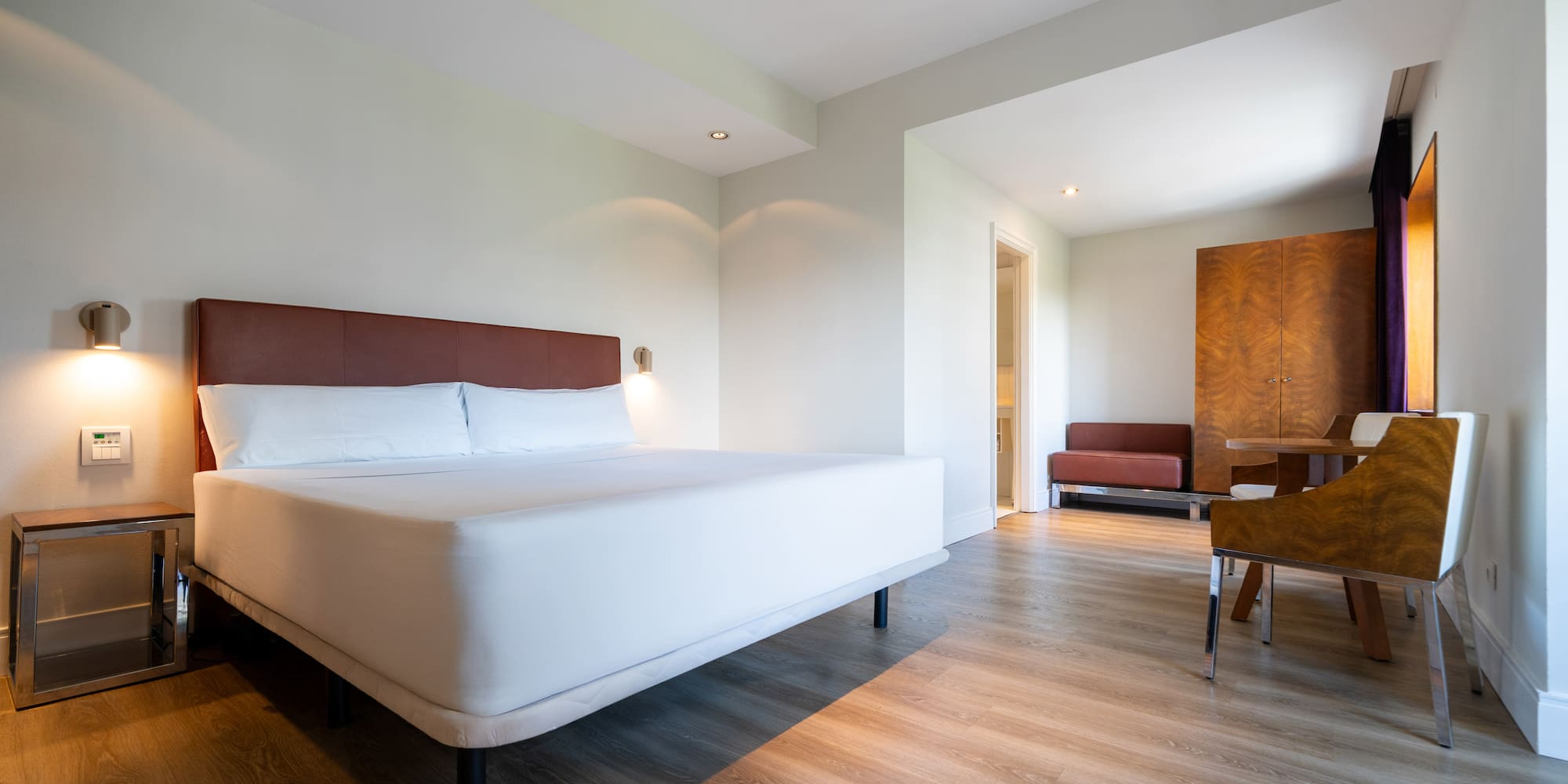 a room with a bed and a wood floor