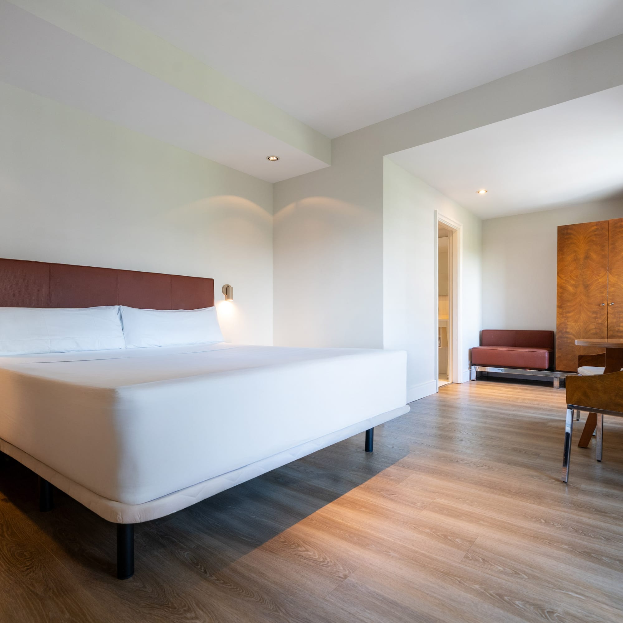 a room with a bed and a wood floor