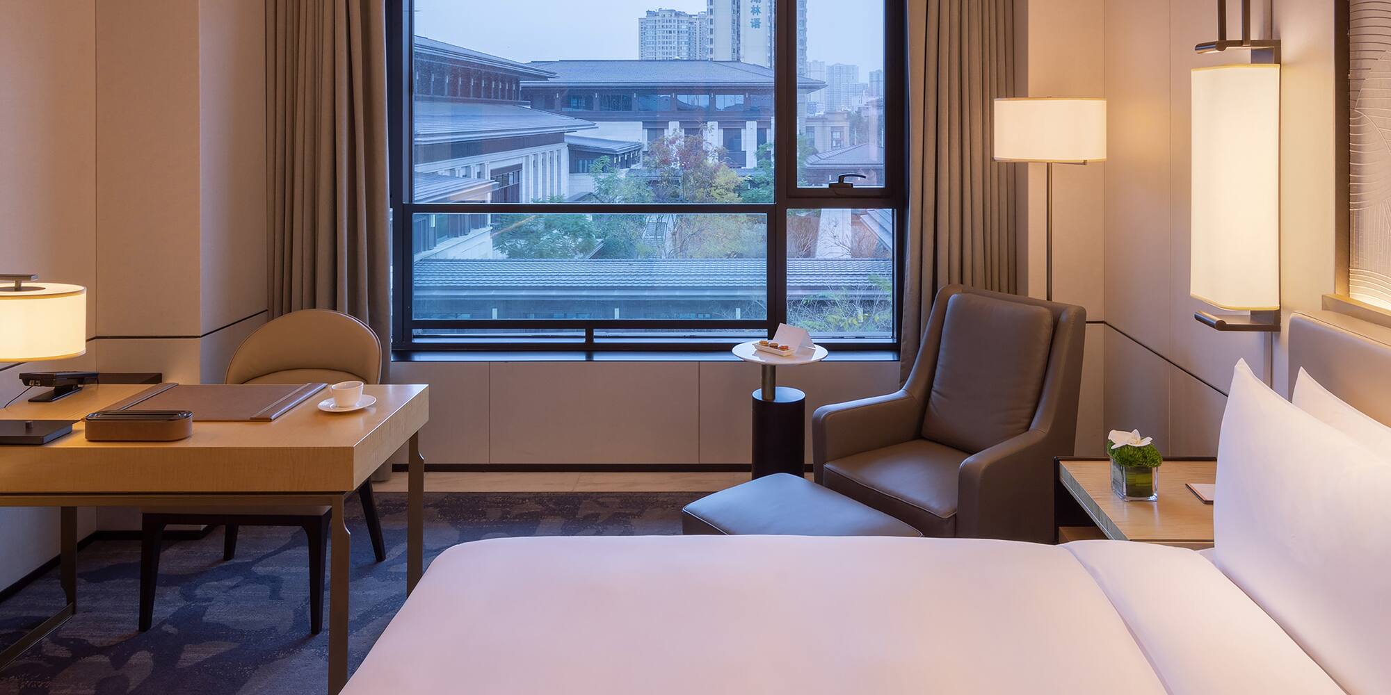 a room with a bed and a table and chairs