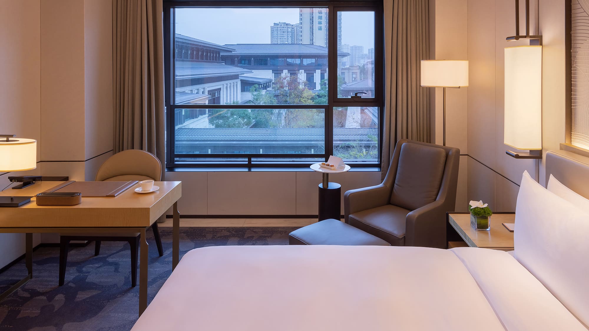 a room with a bed and a table and chairs