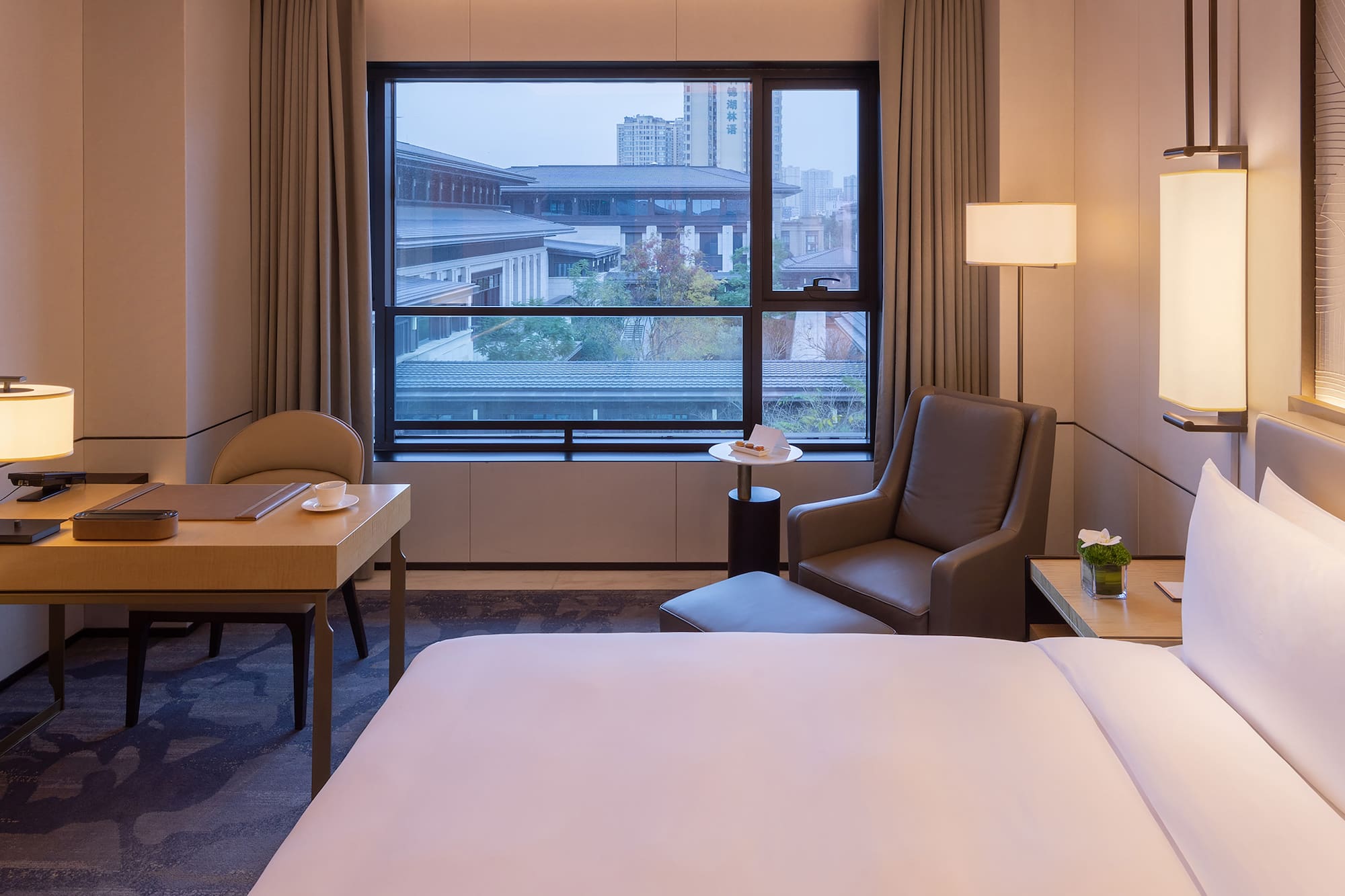 a room with a bed and a table and chairs