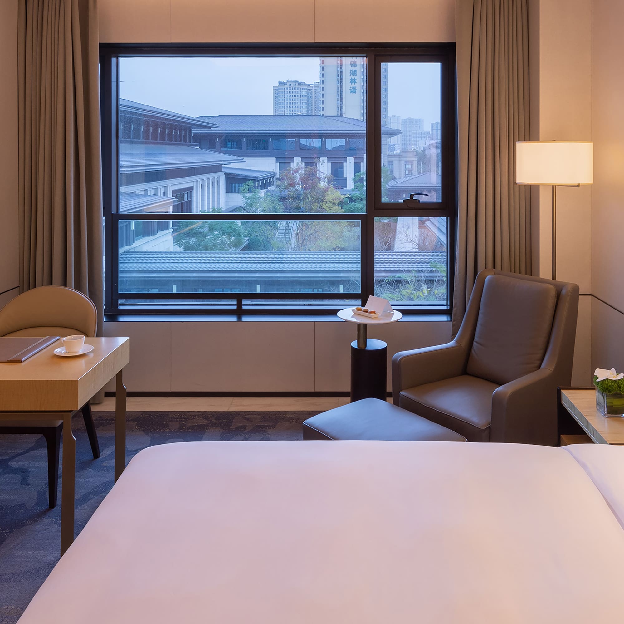 a room with a bed and a table and chairs