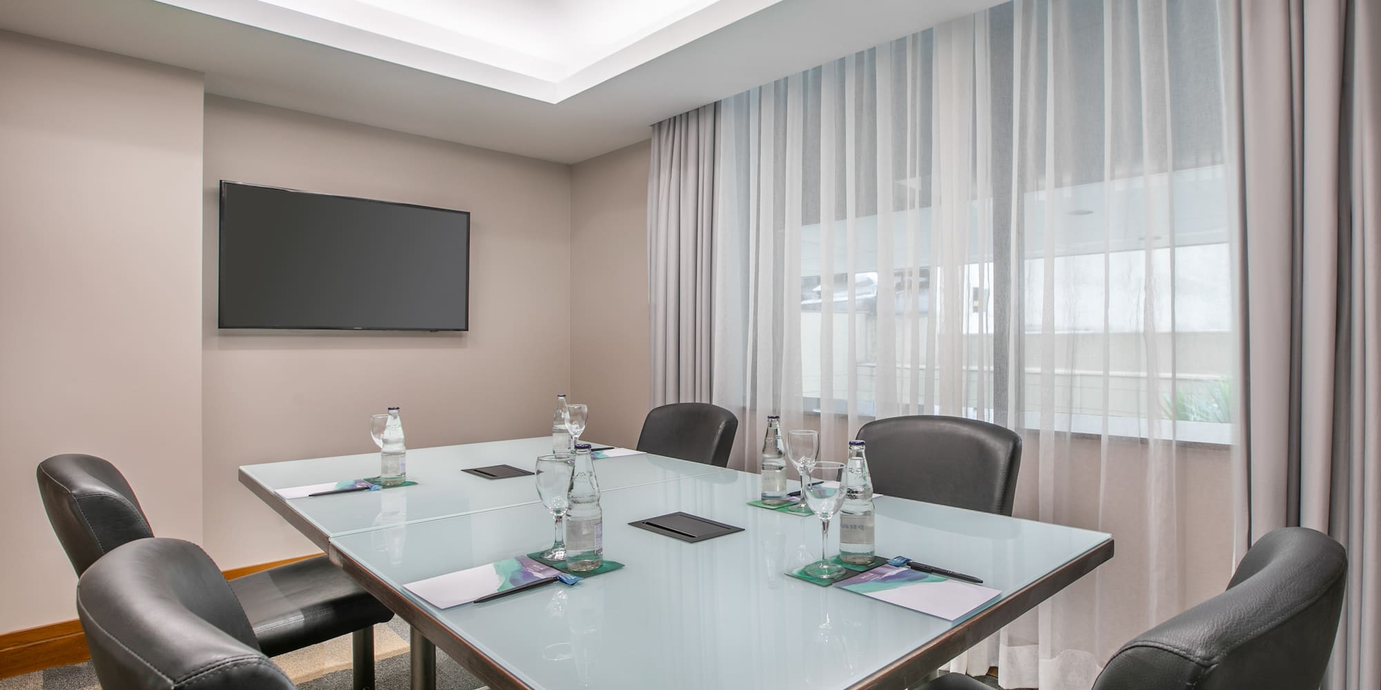 a conference room with a table and chairs