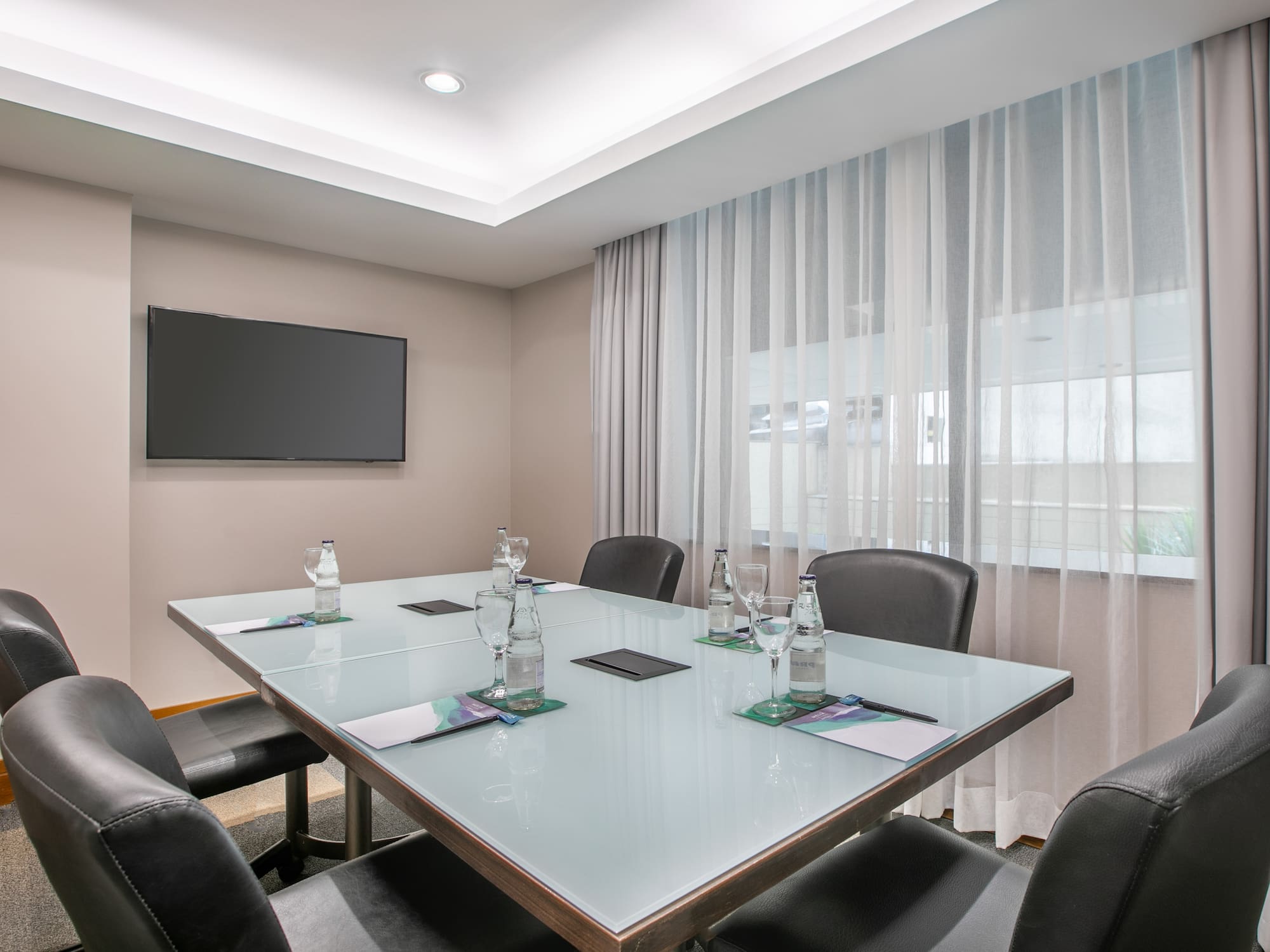 a conference room with a table and chairs
