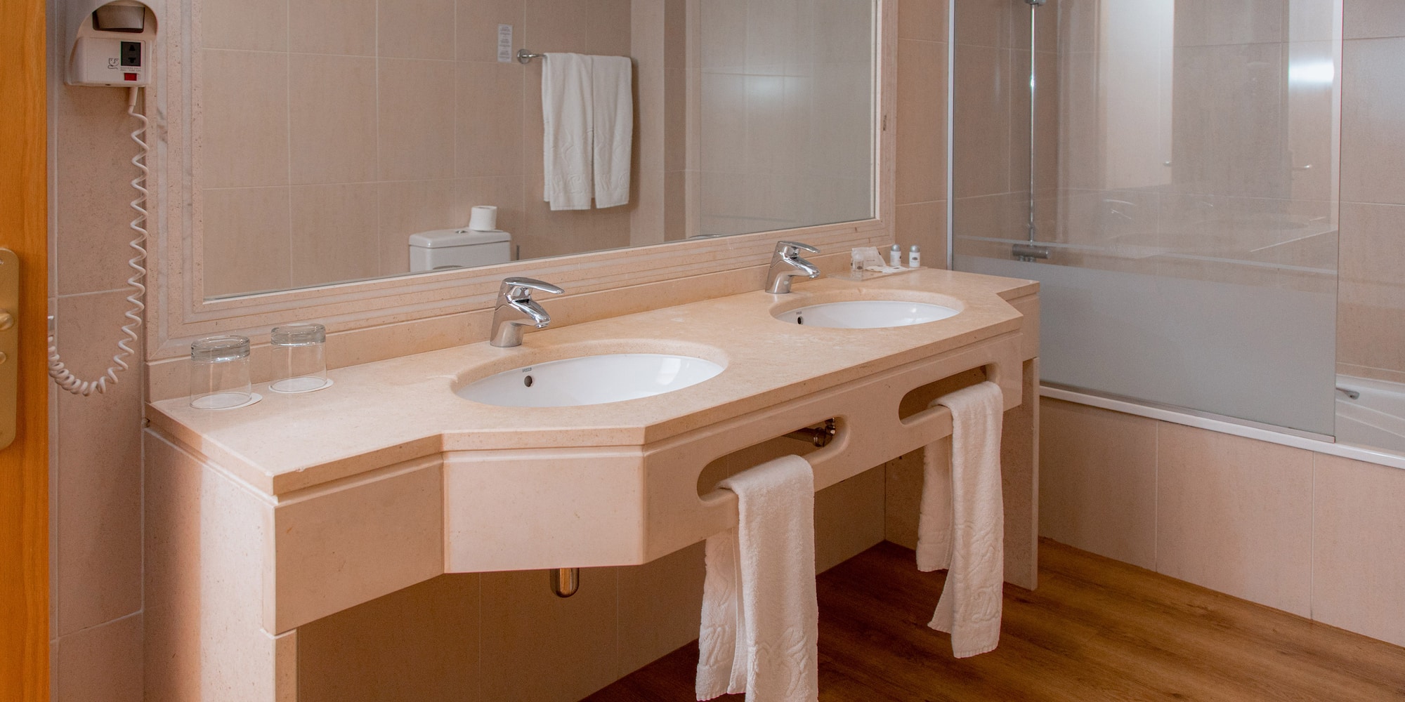 a bathroom with two sinks and a shower