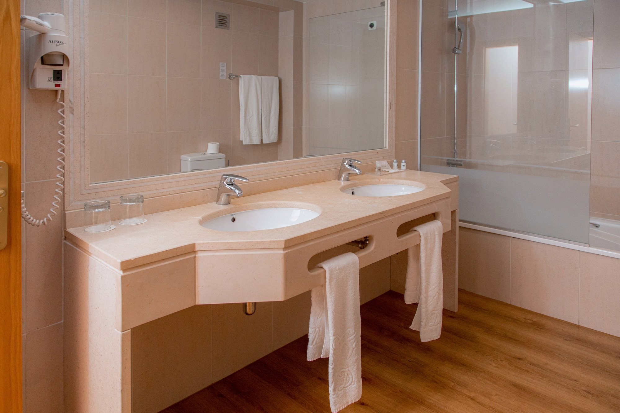 a bathroom with two sinks and a shower