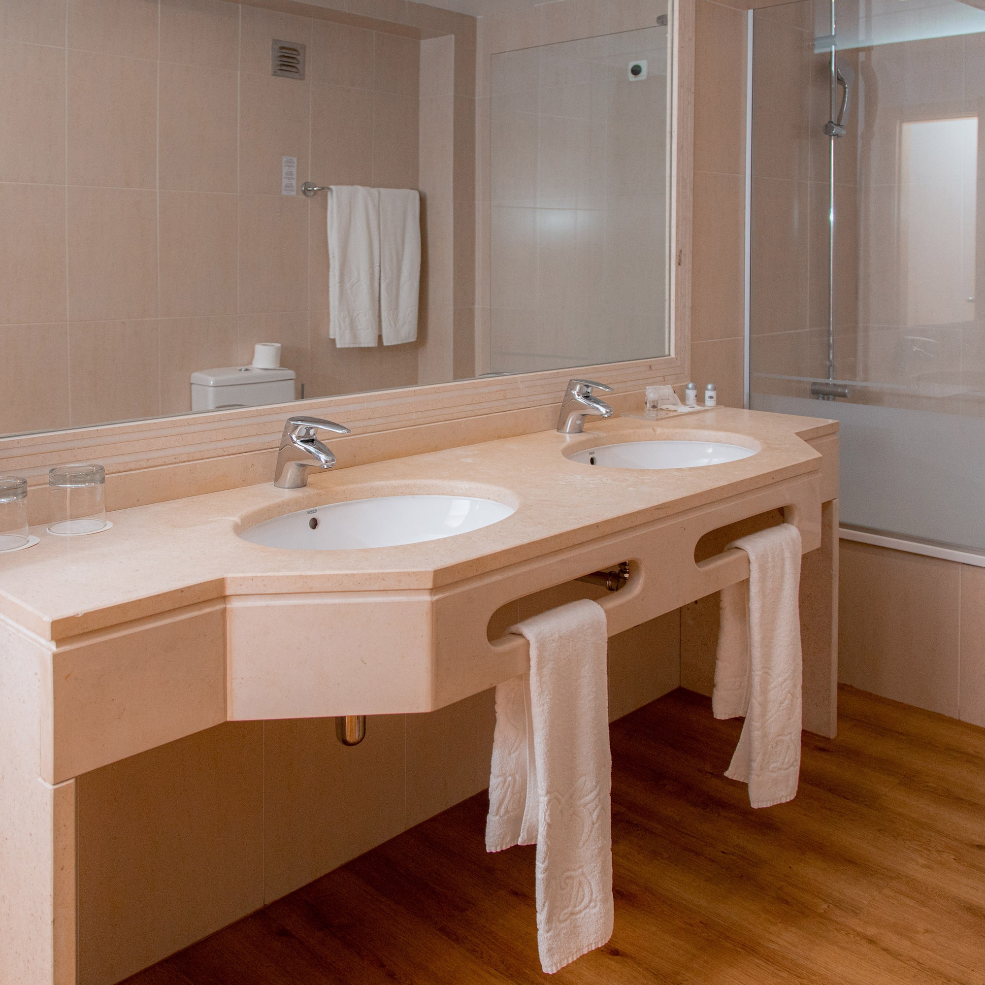 a bathroom with two sinks and a shower
