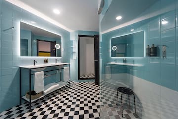 a bathroom with a mirror and a shower