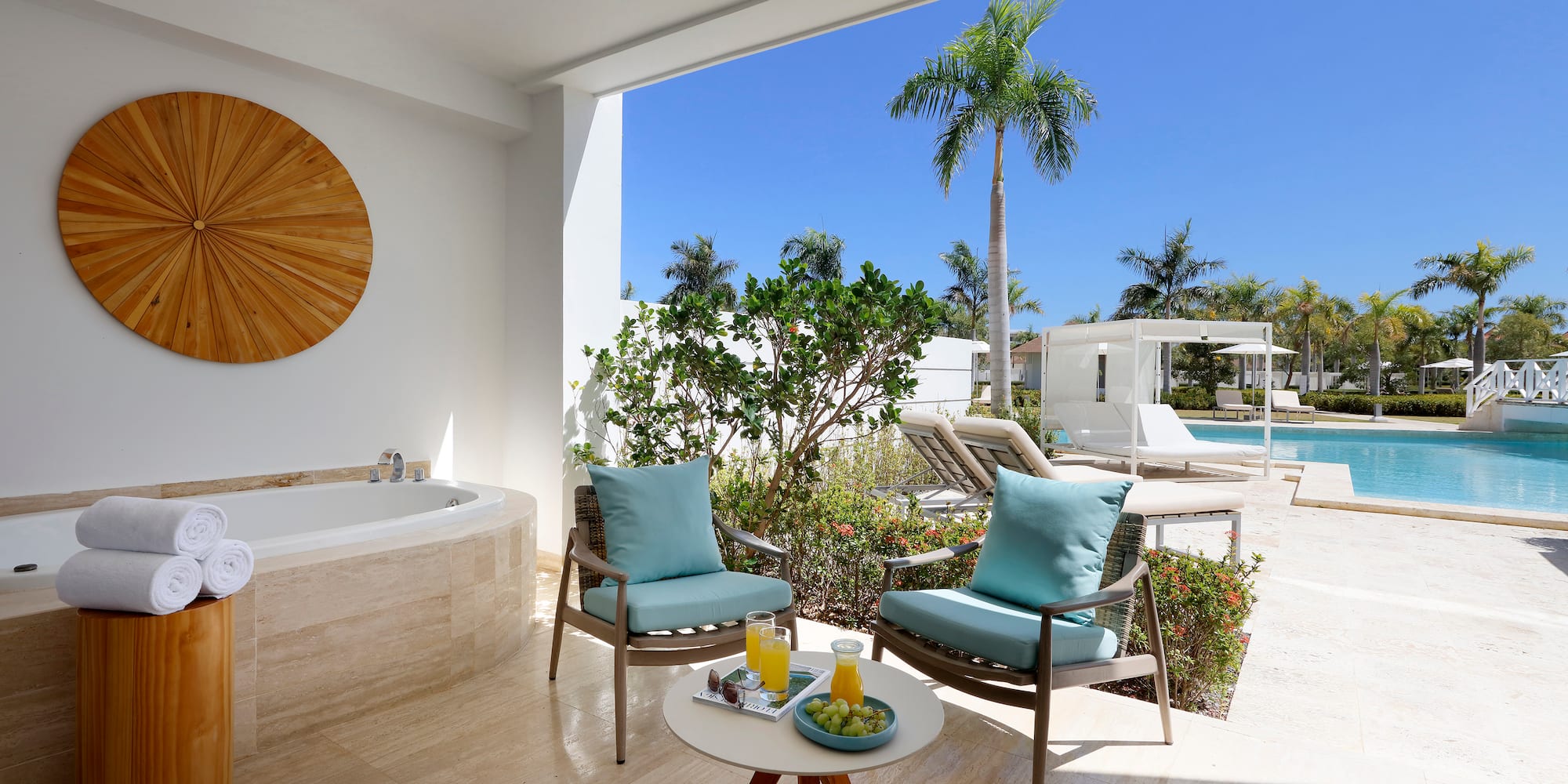 a patio with a hot tub and chairs