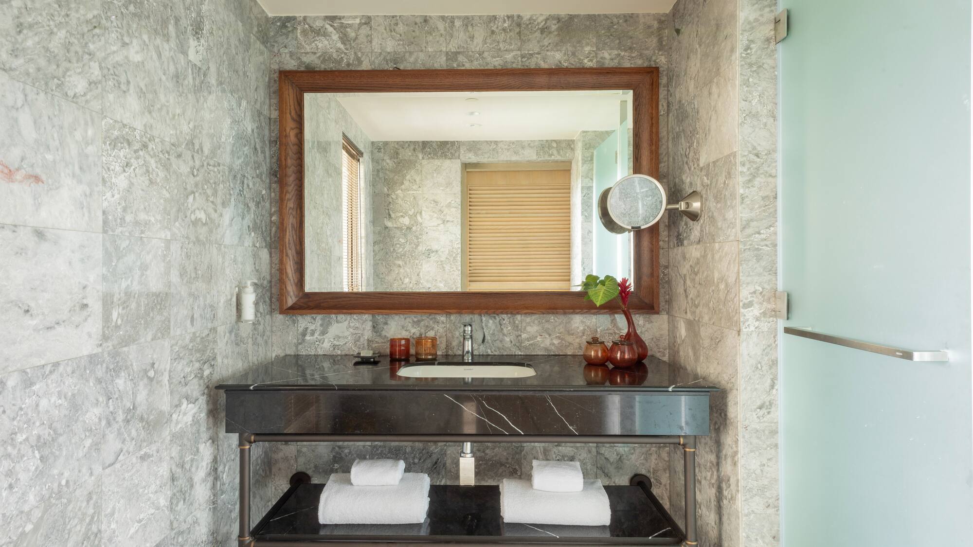 a bathroom with a mirror and a sink
