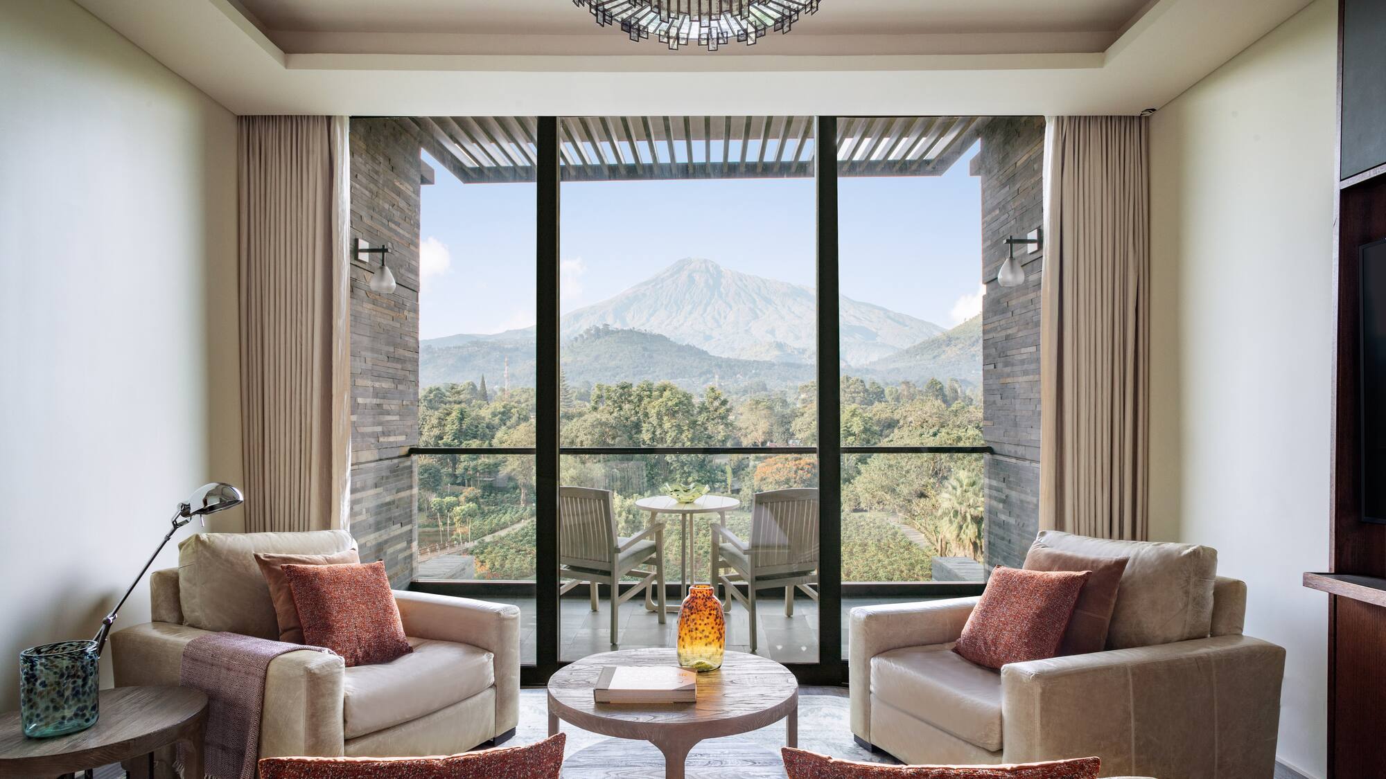 a living room with a view of a mountain and trees