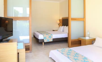 a room with two beds and a tv