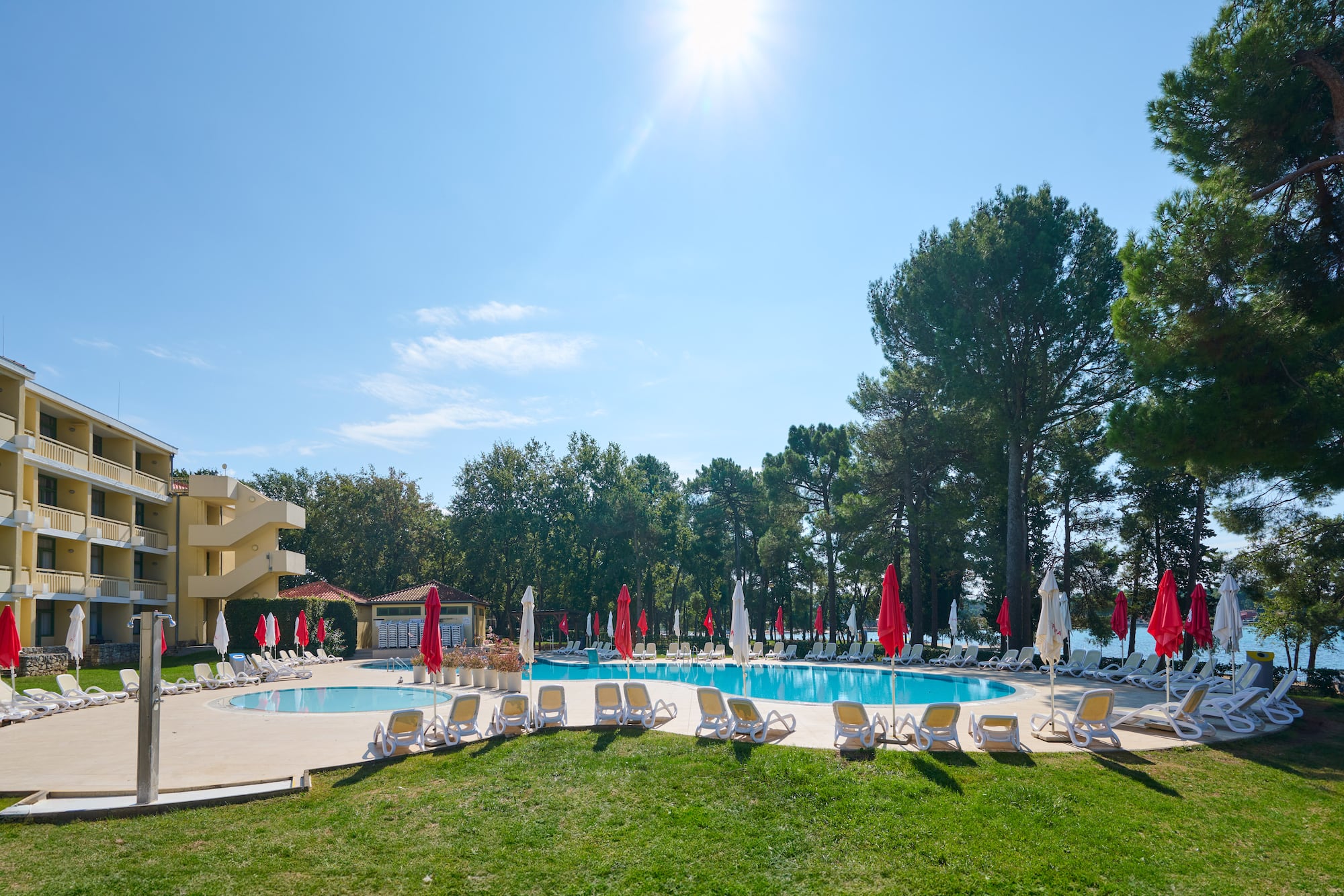 a pool with umbrellas and chairs