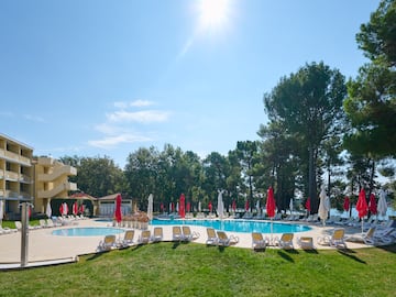 a pool with umbrellas and chairs