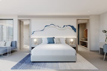 a bedroom with a bed and a rug